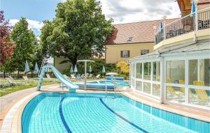 a swimming pool with a slide in a house at Lovely Home In Bad Waltersdorf With House A Panoramic View in Bad Waltersdorf