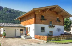 a house with a wooden roof at Stunning Apartment In Mhlbach With Kitchen in Hollersbach im Pinzgau