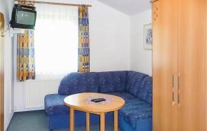 a living room with a blue couch and a table at Amazing Apartment In Radstadt With 2 Bedrooms And Wifi in Radstadt