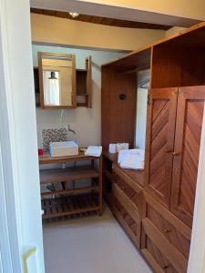a bathroom with wooden cabinets and a sink at Pousada Mar de Dentro in Florianópolis
