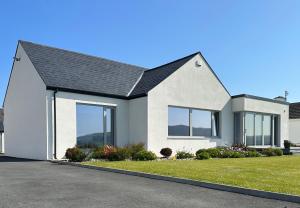 a white house with a black roof at Sea Vista - Rathmullan in Rathmullan