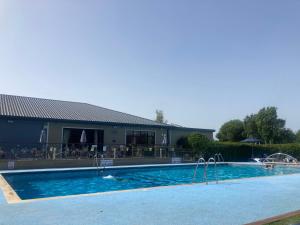 a large swimming pool in front of a building at Rockley Park in Lytchett Minster