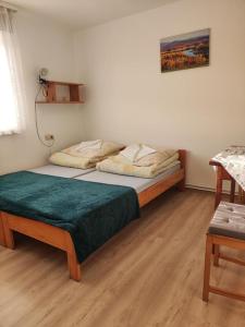 a bedroom with a bed with a green blanket on it at DG EWA w Polańczyku in Polańczyk