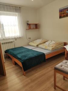 a bedroom with two beds and a window at DG EWA w Polańczyku in Polańczyk