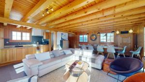 a living room with a couch and a table at Narnia SKI IN & SKI OUT chalet 14 pers in Les Collons