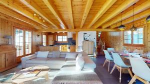 a living room with a couch and a table at Narnia SKI IN & SKI OUT chalet 14 pers in Les Collons