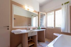 a bathroom with a sink and a large mirror at Eklekti House in Firókambos +34 photos