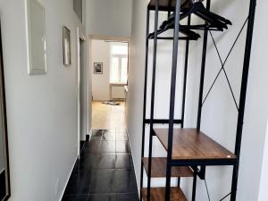 a hallway with a wooden shelf and a staircase at Kienmayer Apartment Vienna in Vienna