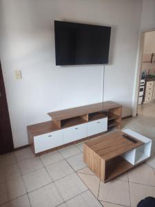 a living room with a flat screen tv on a wall at Departamento céntrico en San Nicolas IG martindebra22 in San Nicolás de los Arroyos +7 photos