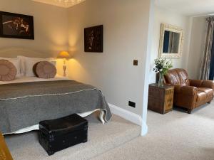 a bedroom with a bed and a couch and a chair at No 22 in Barnstaple