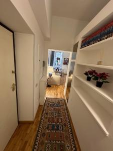 a hallway with a rug on the floor of a room at House of the Sun in Trastevere in Rome