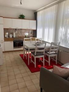 a kitchen with a table and chairs in a room at Haus zur Eiche 1 in Dahme