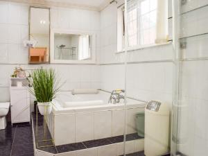 a bathroom with a tub and a sink and a toilet at Valencia in Blackpool +30 photos