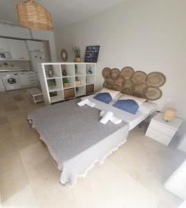 a bedroom with a large bed with a wooden headboard at Sol y Arte Suites Málaga Centro in Málaga