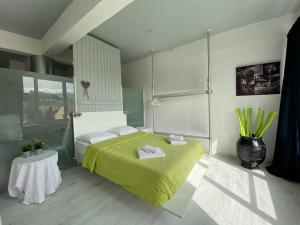 a bedroom with a yellow bed and a table at COMBO Acropolis view 6 bedrooms 4 bathrooms in Athens