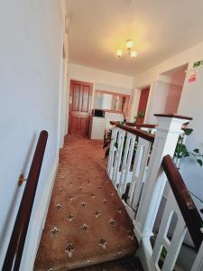 a staircase in a house with a stair case at Thornbury Accommodation in Burnham on Sea