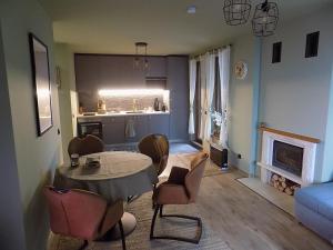 a living room with a table and chairs and a kitchen at La'Vista in Smolyan