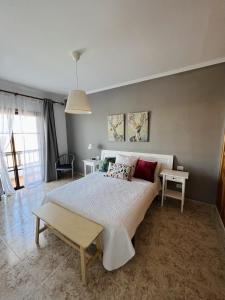 een slaapkamer met een groot bed en 2 tafels bij Casa Cielo in Arrecife