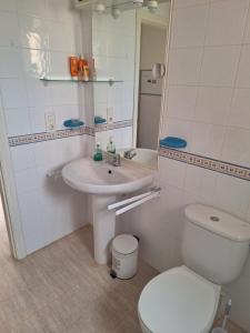 a white bathroom with a toilet and a sink at Vera Sol y Mar - Naturist Zone in Playas de Vera +20 photos