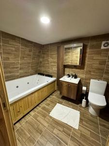 a bathroom with a tub and a toilet and a sink at Gardan Bungalov in Çatalca +31 photos
