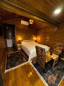 a bedroom with a bed and a table and chairs at Gardan Bungalov in Çatalca