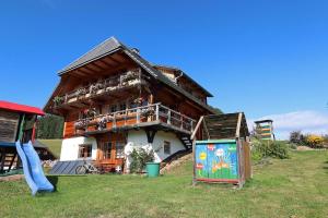 a large wooden house with a playground in front of it at Balzenhof in Titisee-Neustadt