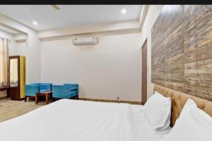 una camera con un letto e due sedie blu di Hotel Amrapali Inn Jaipur a Jaipur