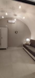 a living room with a bed and a refrigerator at Itinerario Barocco in Ragusa