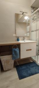 a bathroom with a sink and a mirror at Itinerario Barocco Apartment Ragusa Ibla - Eleganza e Comfort nel Cuore del Barocco Siciliano in Ragusa