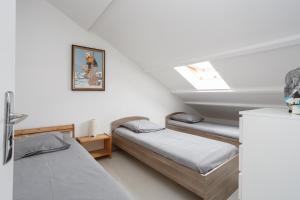 a bedroom with two beds and a skylight at Le blanc gauche BAT A 3ème étage in Le Blanc-Mesnil