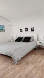 ナポリにあるCasa Stellaの白いウッドフロアのベッドルーム(ベッド1台付)