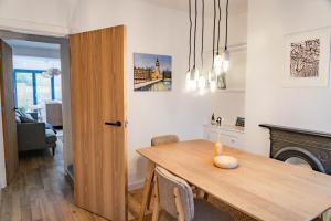 a kitchen and dining room with a table and chairs at Benyon Street Townhouse in Shrewsbury