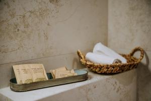 a basket of towels and a book on a shelf at Cichy Brzyzek in Biały Dunajec