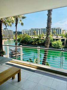 a balcony with a view of a body of water at Modern, beautiful 1 bed with views -V&A Waterfront in Cape Town