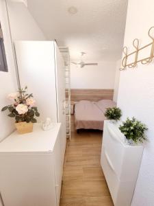 a small room with a staircase and a bedroom at Elizabeta - Playa Mil Palmeras in Campoamor