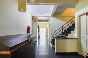 a hallway of a building with a stair case at The Olive Shine in Mysore