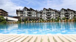 a large swimming pool in front of a building at PARADISE RELAX APARTMENT in Bansko
