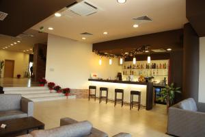 a lobby with a bar with stools at PARADISE RELAX APARTMENT in Bansko