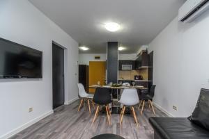 a living room and kitchen with a table and chairs at PARADISE RELAX APARTMENT in Bansko