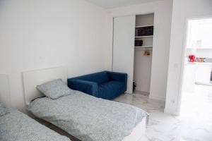 A bed or beds in a room at Splendide grand 3 pièces proche de Paris