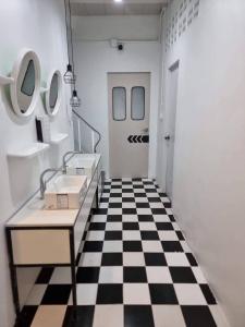 a bathroom with a black and white checkered floor at Matcha House jomtien Pattaya in Jomtien Beach