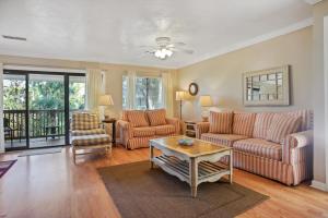 a living room with two couches and a table at 125 Cordillo Parkway in Hilton Head Island