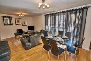 a living room with a table and a couch at Fountainbridge Residence in Edinburgh