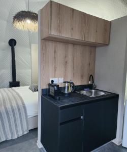 a kitchen with a sink and a bed in a room at River Glamping Kalopanayiotis in Kalopanayiotis +91 photos