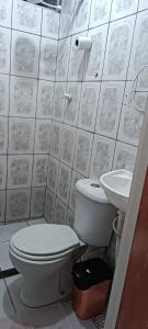 a bathroom with a toilet and a sink at Pousada Praia Avenida in Maceió