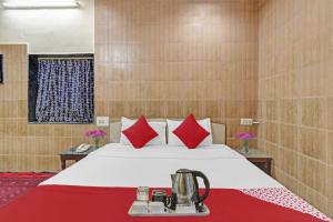 a hotel room with a bed with red pillows at Hotel Rajdoot Near Phoenix Palladium in Mumbai