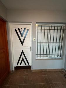 a room with a white door and a window at Apartamentos La Posta in San Salvador de Jujuy