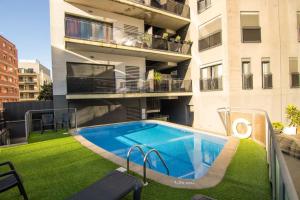 a swimming pool on the side of a building at SeaHomes Vacations - ACACIAS Beach&Chic in Lloret de Mar