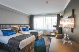 Postel nebo postele na pokoji v ubytování Hotel Agenda Louise