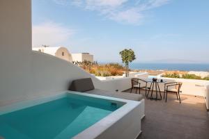 a swimming pool on the roof of a house at North Wind Luxury Suites in Oia